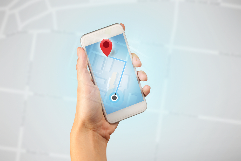 Female fingers touching smartphone with map