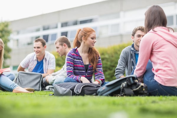 Group of young college students sitting in the park