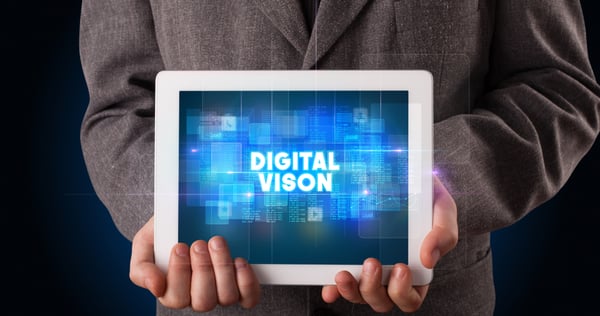 Young business person working on tablet and shows the inscription DIGITAL VISON-1